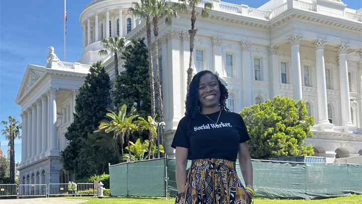 woman stands in front of CA capital building