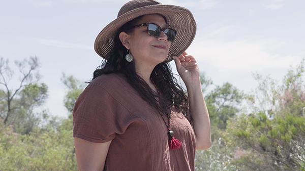 woman wearing sun hat and glasses outside
