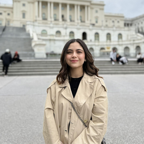 Isabela Perez- Political Science: smiling woman in front of capital building