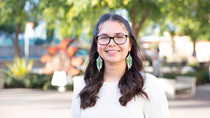 woman with long dark hair wearing glasses