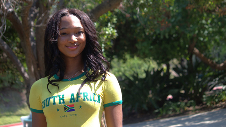 smiling woman with dark hair wears South Africa shirt