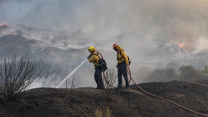 two firefighters put out fire