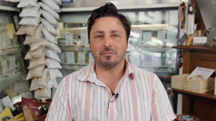 man in cheese shop