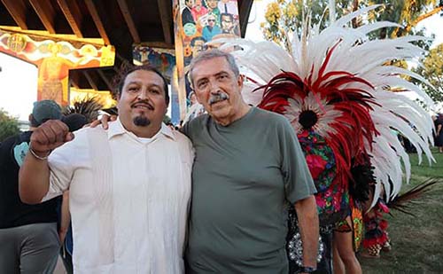 Jose Olague (left) posed at his Chicano Park mural (center column) with professor emeritus Alberto Ochoa. 