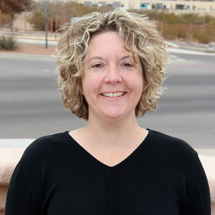 smiling woman with short blonde wavy hair