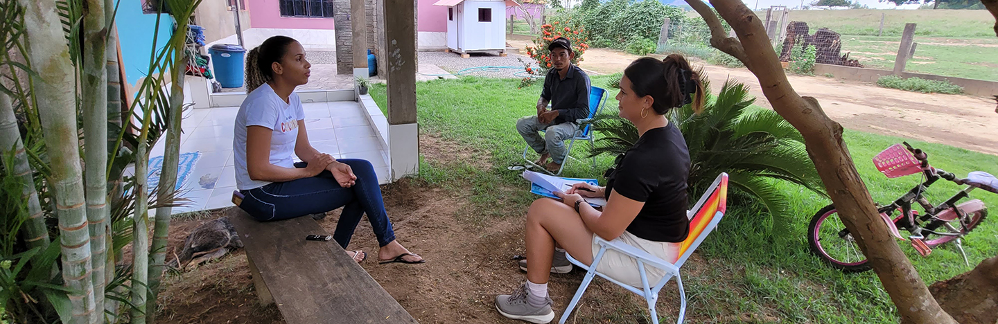 female student interviews another female while a male looks on